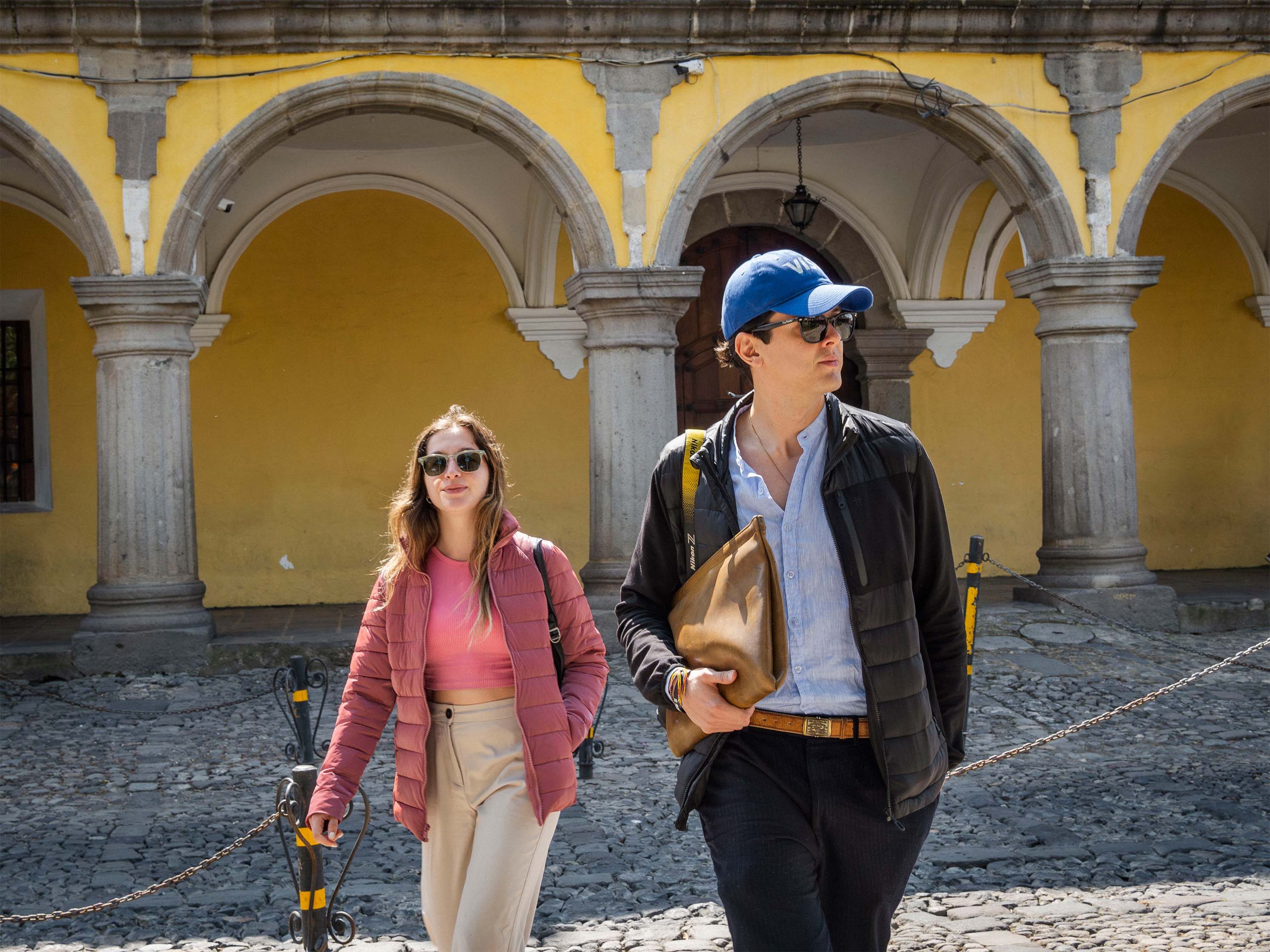 A person looking thoughtfully at a wall of questions